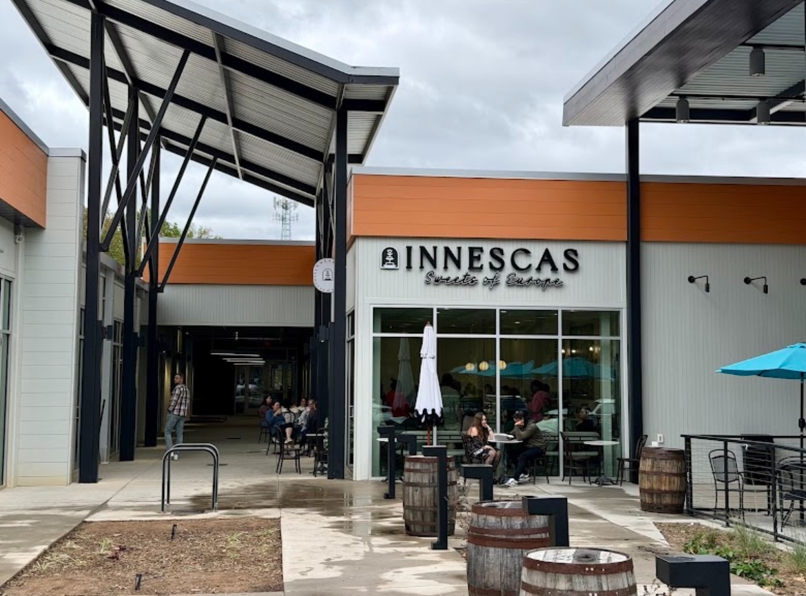 Elegant pastry display with layered cakes and dessert cups